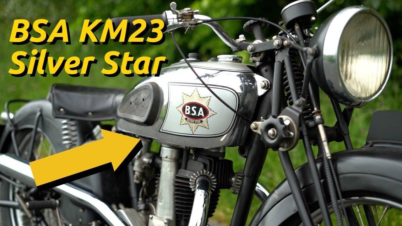 Close front view of a silver and black BSA KM23 Silver Star with a yellow title and arrow.