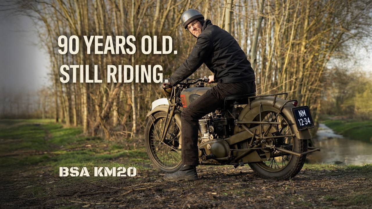Rider seated on a khaki BSA KM20 beside water, with text reading “90 years old, still riding”.